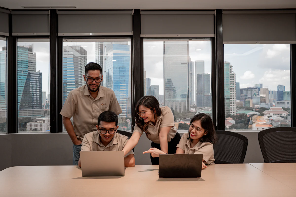 Colleagues working together with laptops in an office.