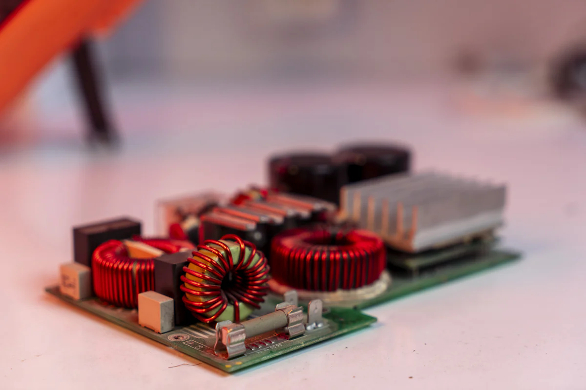 A circuit board with electronic components on a white surface.