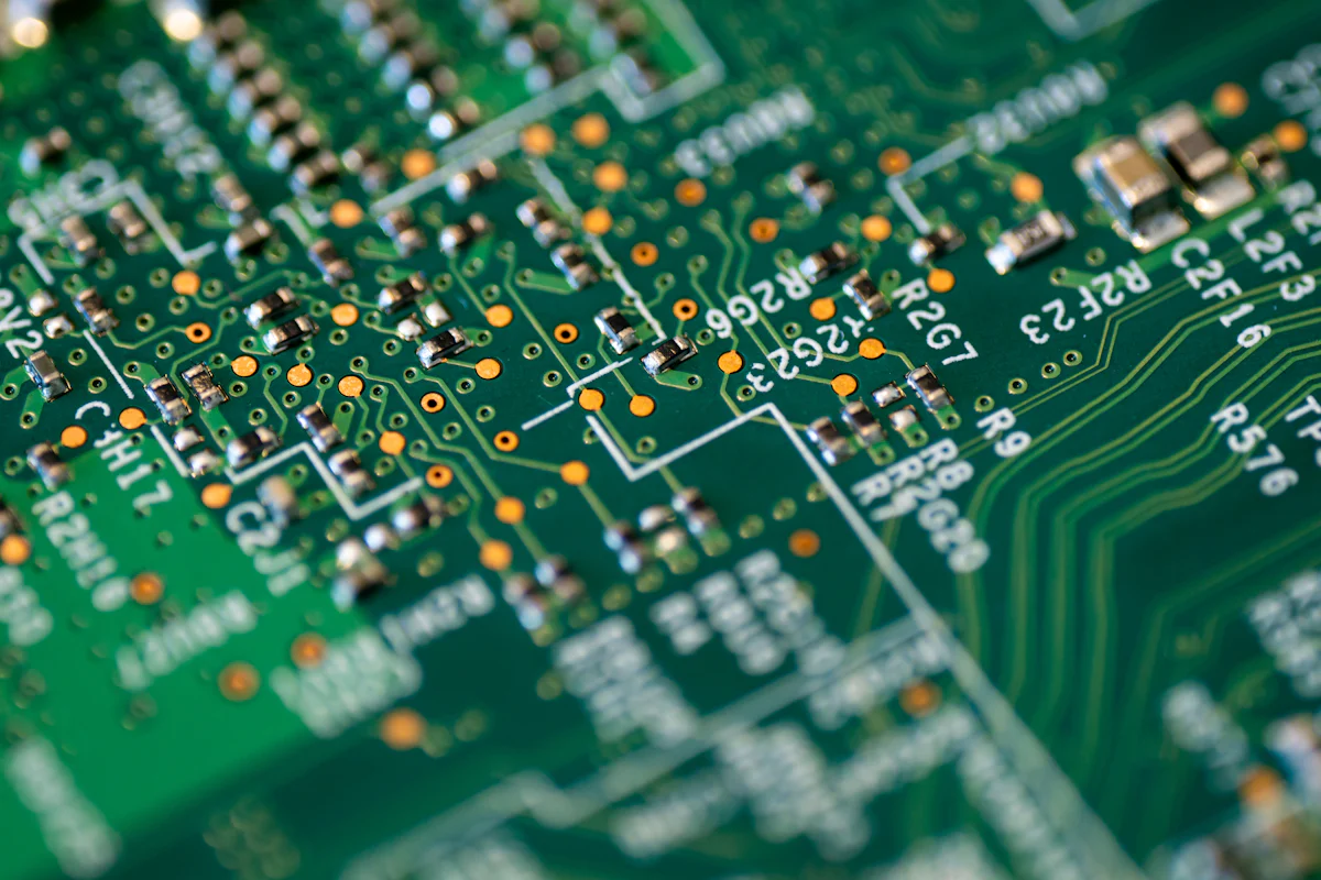 Close view of components and paths on a green motherboard.