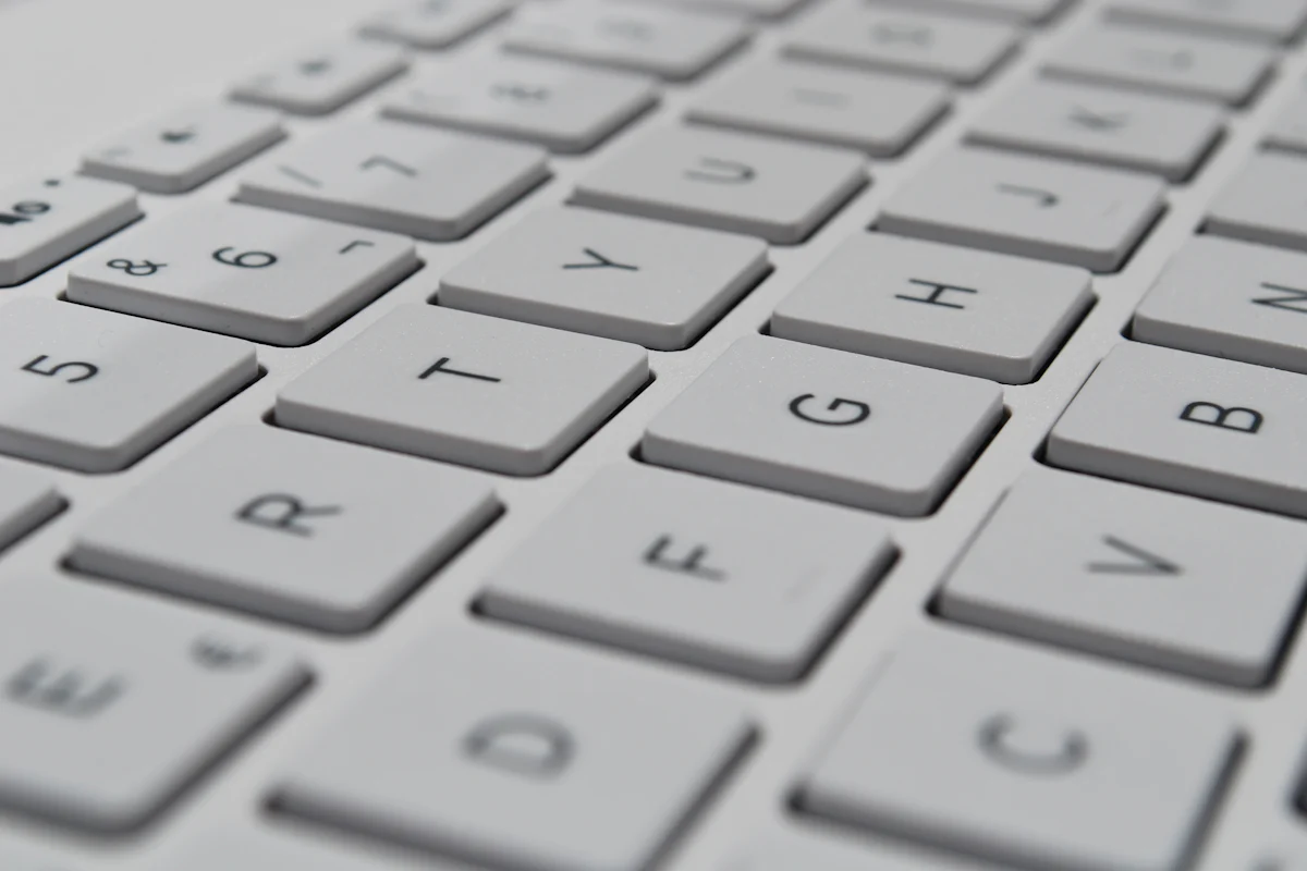A close-up of keys on a white computer keyboard.