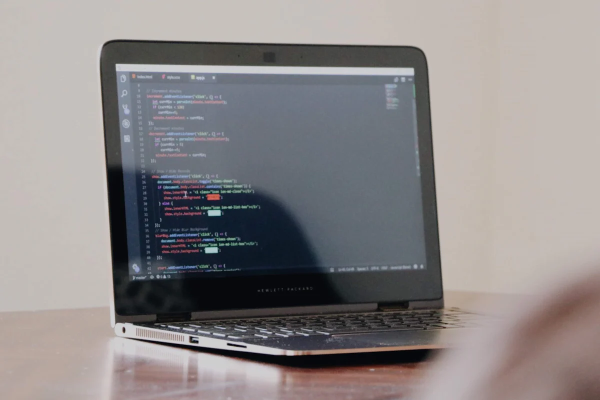 A laptop screen displaying programming code.