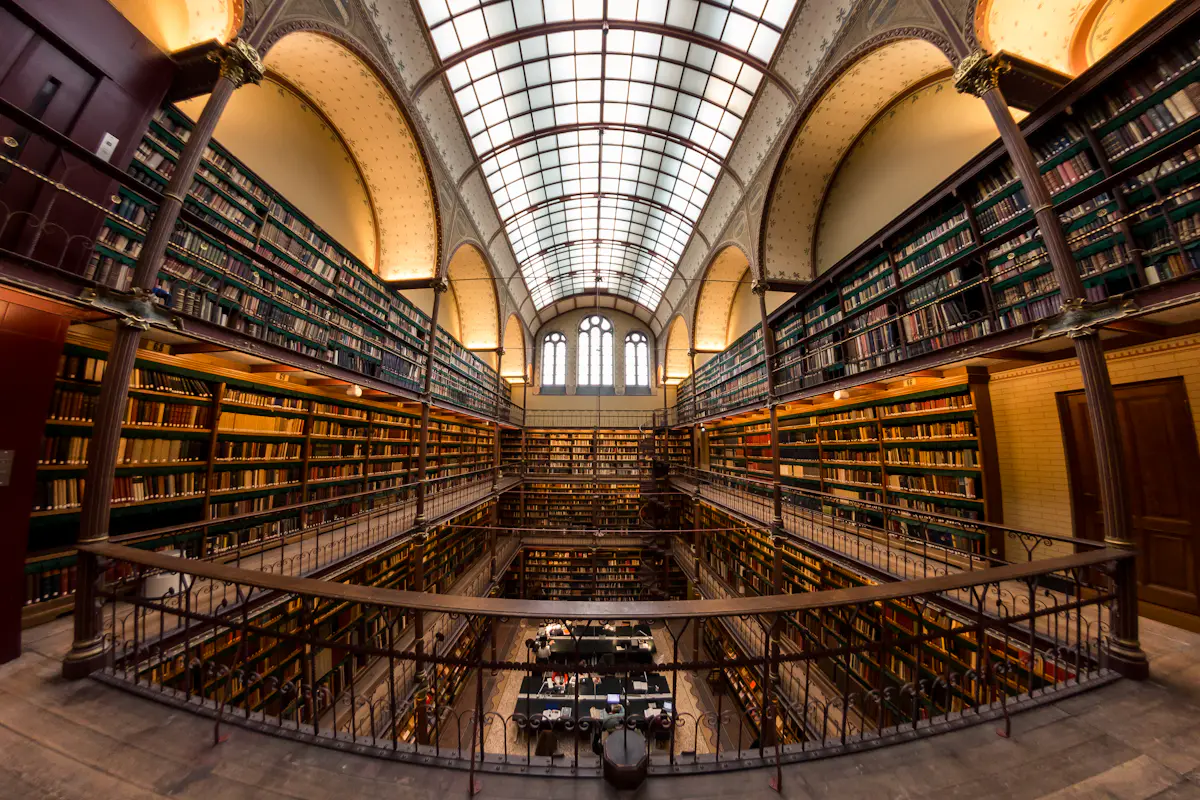 The interior of a library with organized shelves and stairways.